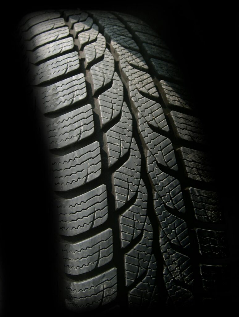 Detailed close-up image of a rubber tire showcasing texture and tread pattern, ideal for design concepts.